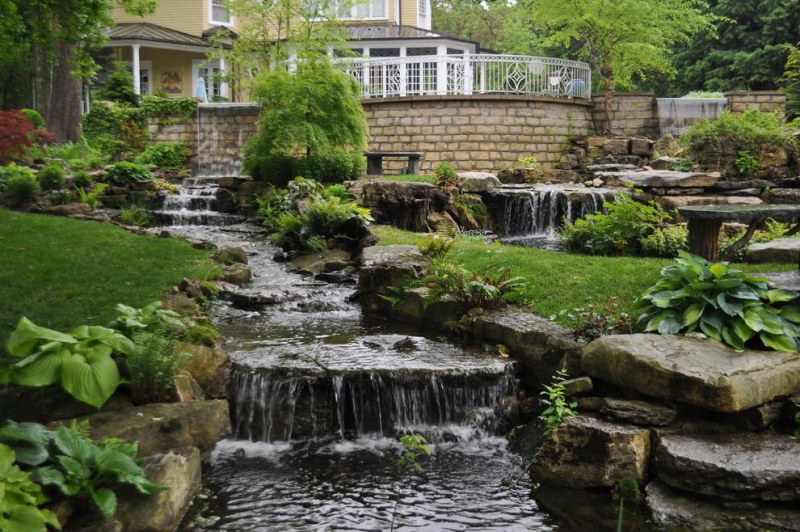 paysagiste-VALLAURIS-min_landscaping-rock-louisville-ky-traditional-landscape-and-boulders-brick-wall-bushes-grass-koi-law